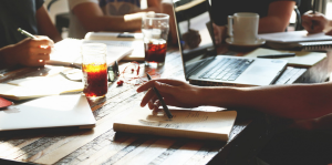 Close up of table with notebooks and a laptop
